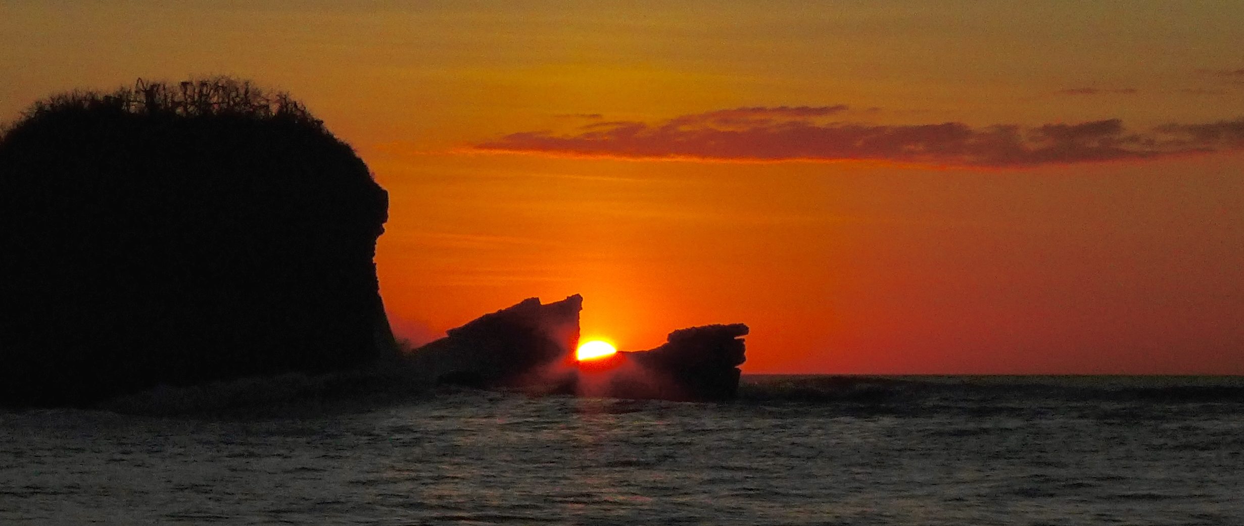 Sunset between the anvils at playa pelada, Nosara Costa Rica