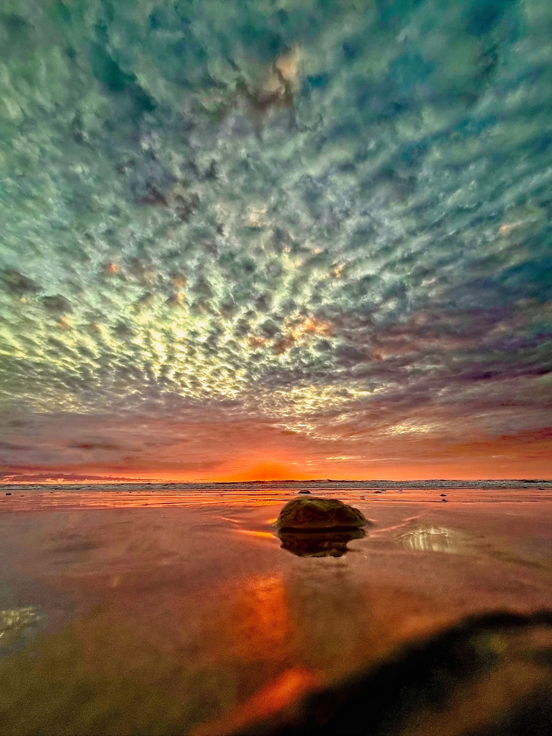 colorful popcorn sunset at playa guiones, nosara, costa rica