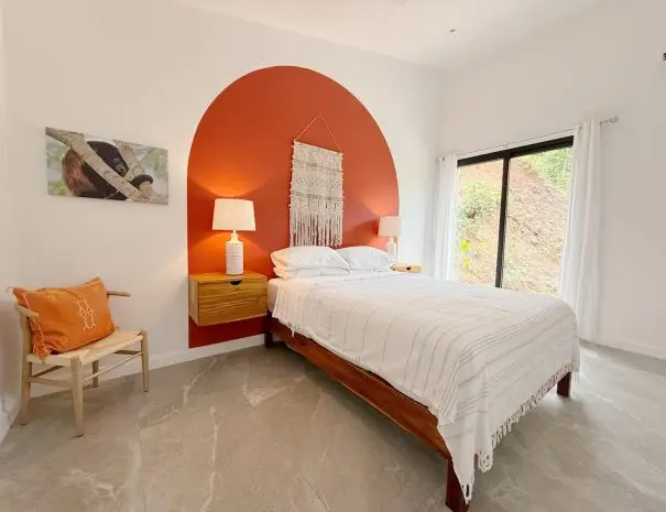 Master bedroom in Villa 1 with queen bed and panoramic jungle views