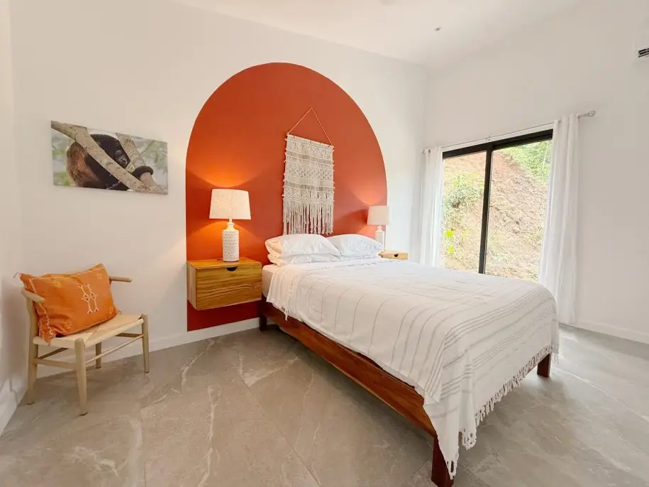 Master bedroom in Villa 1 with queen bed and panoramic jungle views
